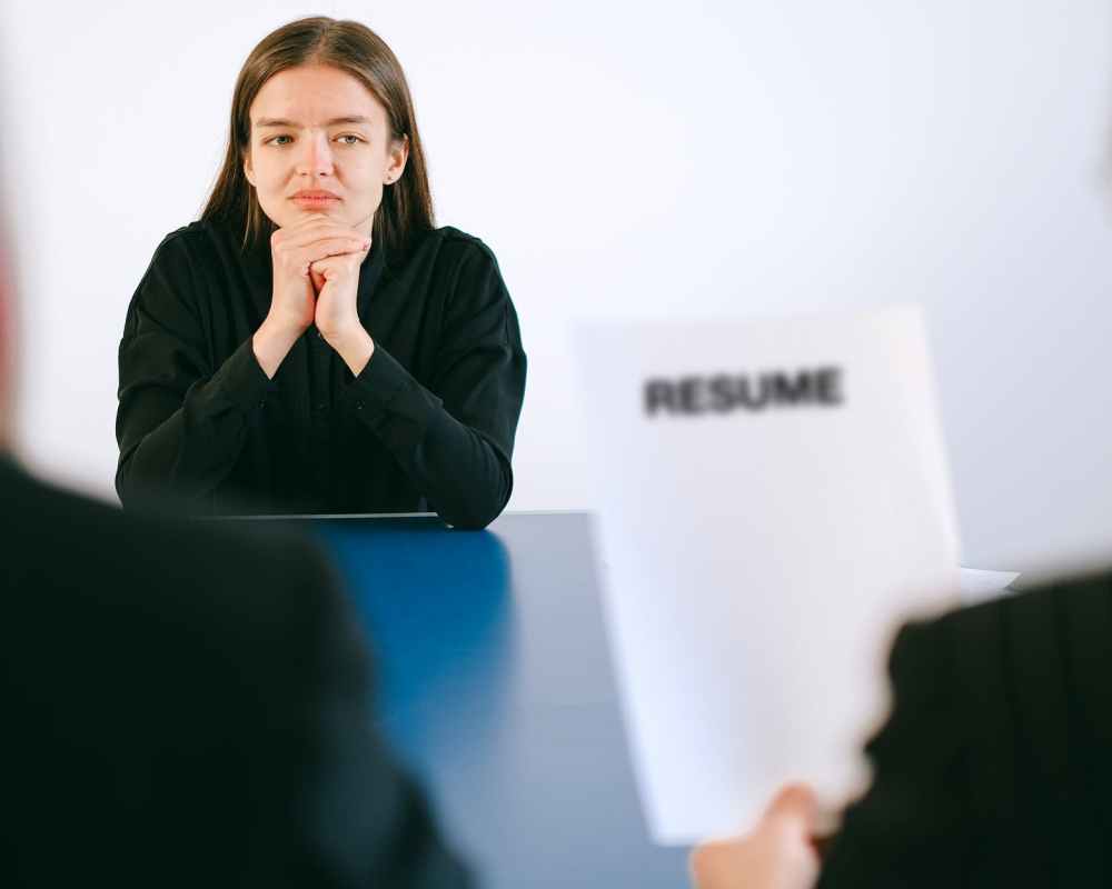 woman in black long sleeve shirt sitting having interview